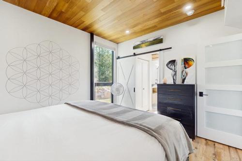a bedroom with a white bed and a window at Tree Farm Sanctuary in Basalt