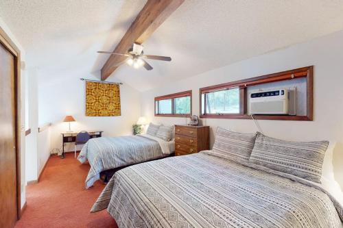 a bedroom with two beds and a ceiling fan at Whispering Pines 323 in Durango