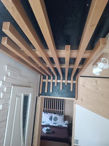 a room with a bed and a ceiling with beams at evkalipt in Ivano-Frankivsk