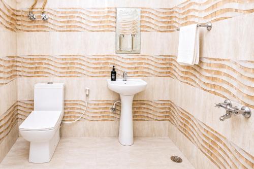 a bathroom with a toilet and a sink at Hotel Golden Ring in Lucknow