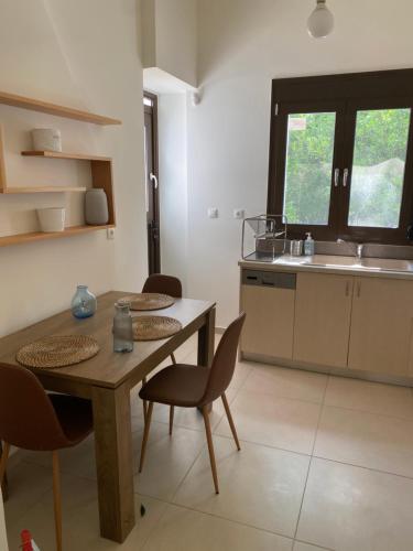 a kitchen with a table and chairs and a sink at CasaKOS in Kos
