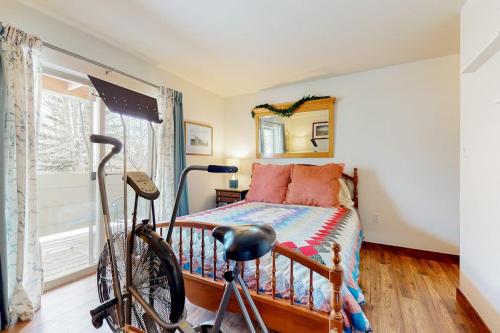 a bedroom with a bed and a bike in front of it at Frisco Home Base in Frisco