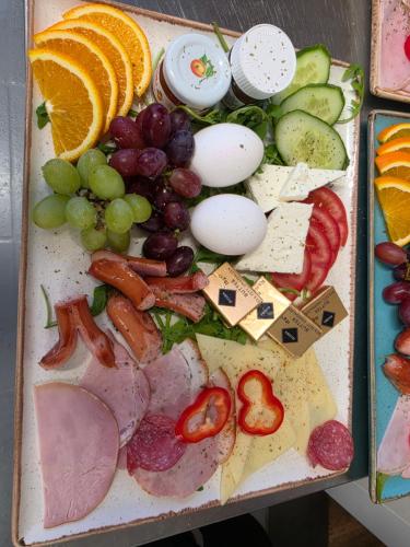a tray filled with different types of meats and vegetables at Hotel Restaurant Yiamas in Breitenworbis