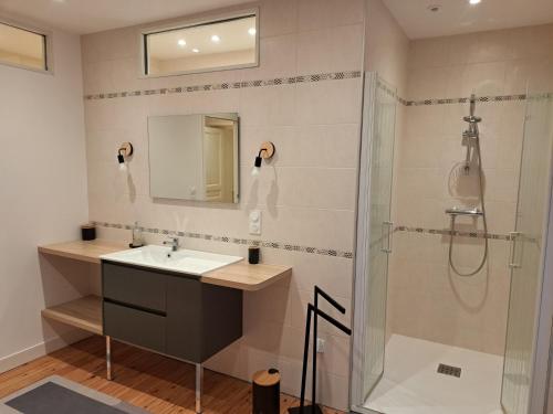 a bathroom with a sink and a shower at Gîte Lebasladin in Lison