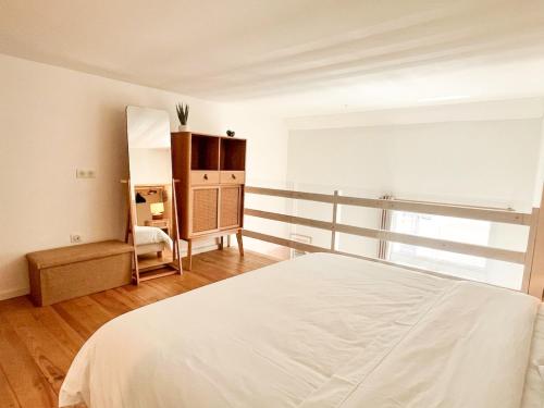 a bedroom with a white bed and a mirror at Large 2 bedrooms Duplex - City Center & free Parking in Arcachon