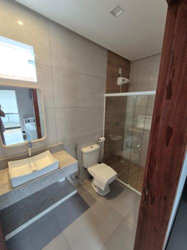 a bathroom with a toilet and a sink and a shower at NOVO HOTEL in Conceição do Coité