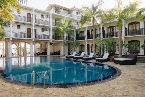 a large swimming pool in front of a hotel at Peacock Wild YALA in Tissamaharama