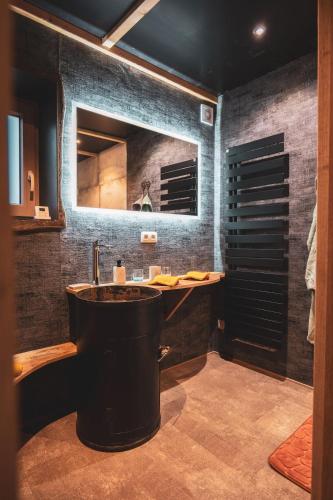 a bathroom with a sink and a mirror at Atelier 69 Loveroom in Paliseul