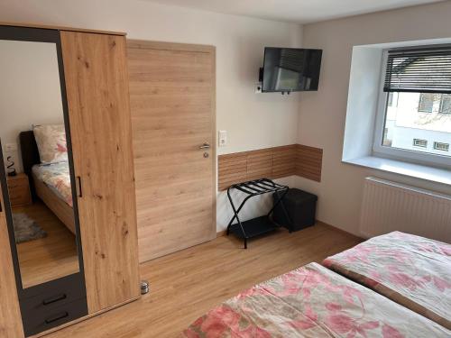 a bedroom with a wooden door and a bed at MyAlpenloft 2 in Deutschgriffen