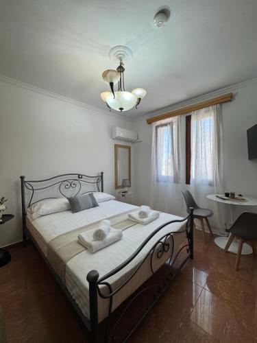 a bedroom with a large bed with towels on it at Almeta Apartments Port in Chios