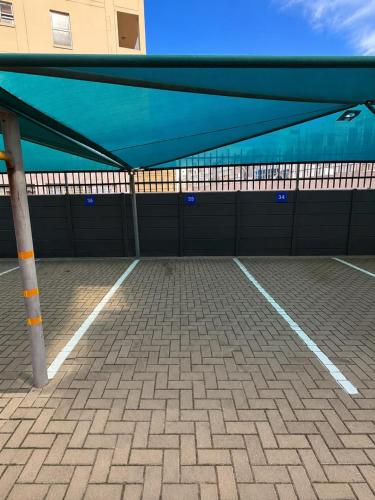 a covered parking lot with a blue roof at Diaz De Valle 35 in Mossel Bay