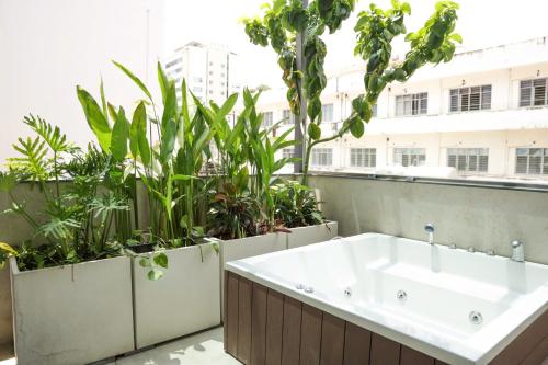 a bath tub on a balcony with plants at AN Studio VVT in Ho Chi Minh City