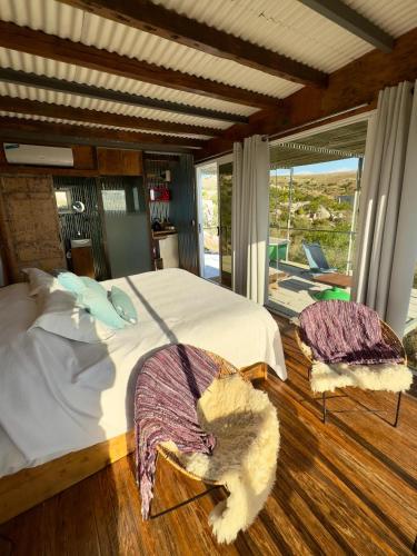 a bedroom with a bed with two pillows on it at Eco-Suite Estación Penitente in Minas