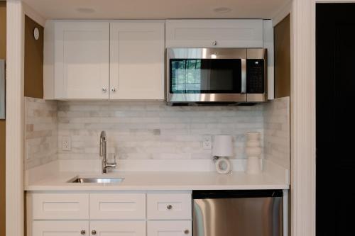 a kitchen with a sink and a microwave at The Concord Hotel in Boston