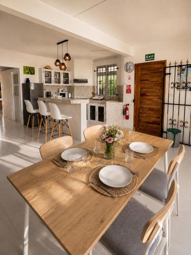 a dining room with a wooden table and chairs at Pointe D'Esny Villa 1 in Mahébourg