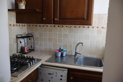 a kitchen counter with a sink and a stove at Eva'house in Bolsena