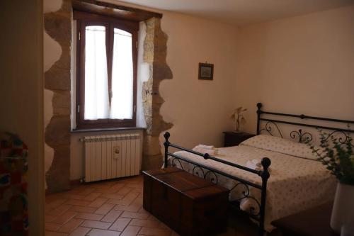 a bedroom with a bed and a window at Eva'house in Bolsena