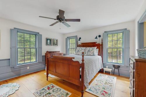a bedroom with a bed and a ceiling fan at Beech Hill Lodge in Freeport