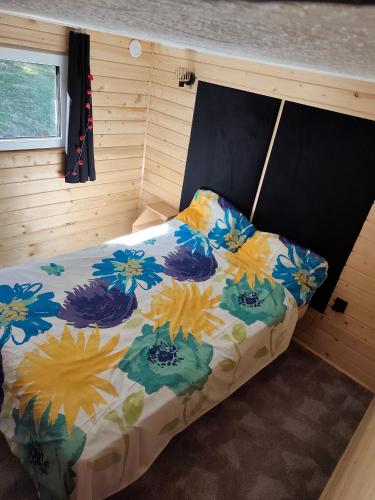 a bedroom with a bed in a small room at Powrót do Natury in Orzyny