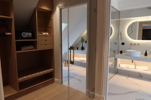a bathroom with a glass shower and a sink at Chateau De Germigney in Port-Lesney