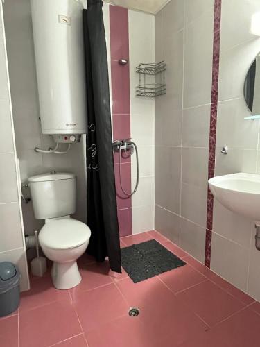 a bathroom with a toilet and a sink at Helga Apartment in Obzor