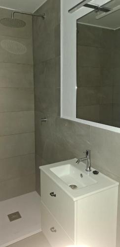a bathroom with a white sink and a mirror at Apartamento Gecko in Son Parc