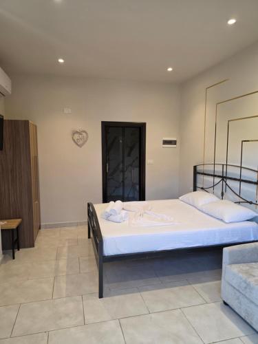 a bedroom with a large bed in a room at Helgis Center in Himare