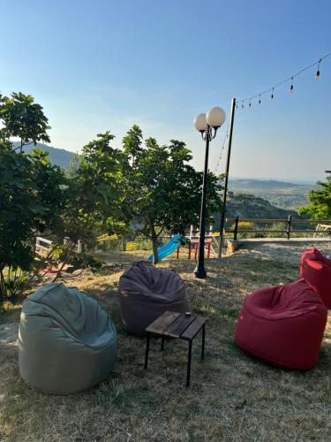 a group of bean bags and a bench in a park at Kështjella Myftari in Patos
