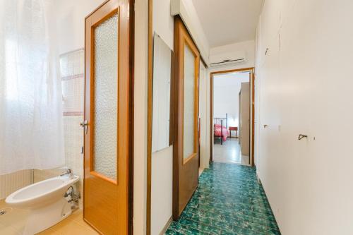 a bathroom with a toilet and a sink at Anna Flat - 2 minuti dalla spiaggia in Lido di Jesolo