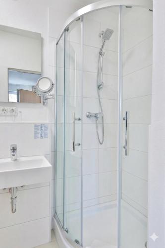 a bathroom with a shower and a sink at Hotel Hecht Garni in Ingolstadt
