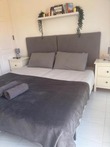 a large bed in a room with two night stands at Mi Amor in Caleta De Fuste