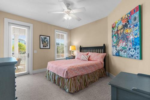 a bedroom with a bed and a ceiling fan at Elegant Beachfront Escape with Wrap-Around Porches in Pawleys Island