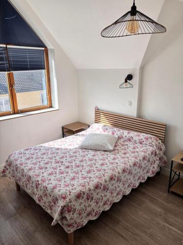 a bedroom with a bed and a window at Hôtel Au Bon coin chez Pierre in Franconville