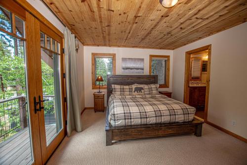 a bedroom with a bed and a wooden ceiling at Bonanza By Hauserman Rentals in Tahoe City
