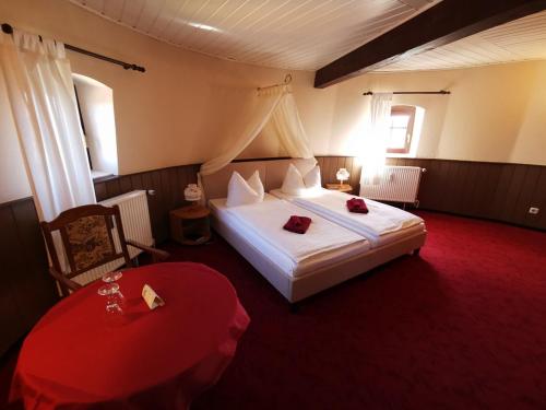 a bedroom with a large bed and a red carpet at Holländer Mühle Rheinsberg in Rheinsberg