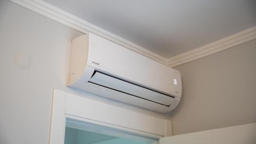 a microwave oven hanging on a wall in a room at Santana Suıts in Trabzon