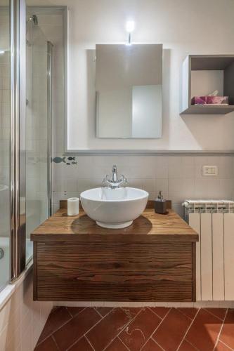a bathroom with a white sink and a shower at Aiuola133 in Cetona