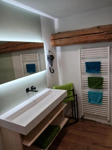 a bathroom with a white sink and a mirror at La grande escapade in Xertigny