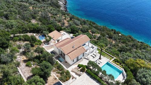 an aerial view of a house with a swimming pool at Villa Lefkas - Luxury villa Sivota with direct sea access in Sivota