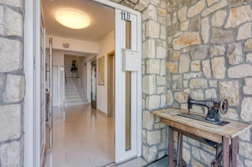 a stone wall with a sink in a hallway at 2Bfree Apartments in Stinica