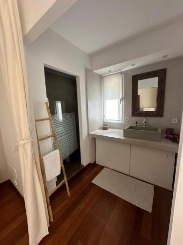 a bathroom with a sink and a mirror at Wonderful Villa Cala Tarida in Sant Josep de sa Talaia
