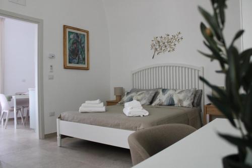 a bedroom with a bed with towels on it at Dimora Letizia, Apulian Rooms in Sammichele di Bari
