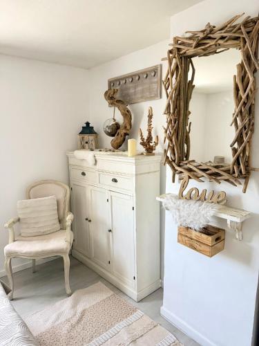 a room with a white dresser and a mirror at La Maison Du Bois Flotté in Boulogne-sur-Mer