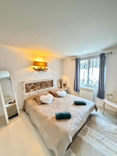 a bedroom with a large bed with two pillows on it at La Maison Du Bois Flotté in Boulogne-sur-Mer