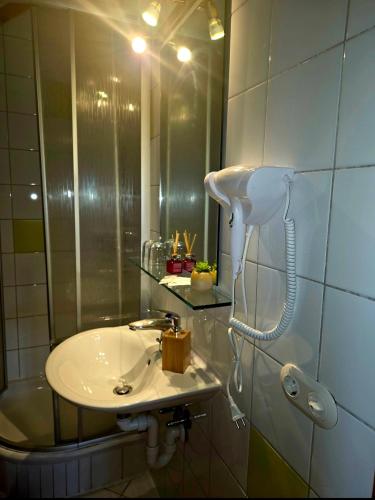 a bathroom with a sink and a mirror at Sonnleit'n Zimmer 3 in Abtenau