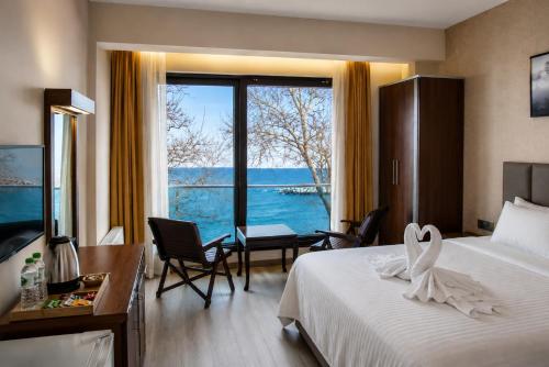 a hotel room with a bed and a large window at Dolphins Otel in Akçakoca