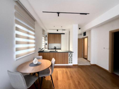 a kitchen and dining room with a table and chairs at Azzurro Vista in Budva