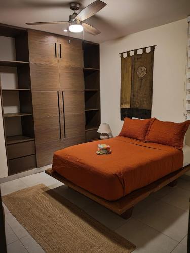 a bedroom with a bed and a ceiling fan at Akumalito Santamar in Akumal