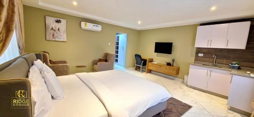 a hotel room with a bed and a kitchen at Ridge Condos Hotel - Phase Three in Kumasi
