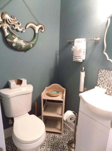 a bathroom with a toilet and a sink at The Lantern in Pensacola